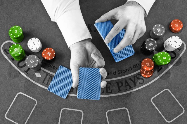 Hands dealing cards surrounded by casino chips