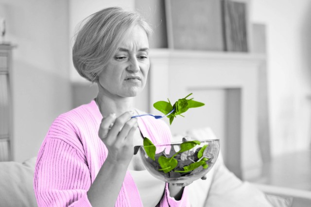 Woman eating spinach