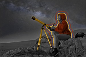 Woman next to a telescope observing the night sky in the desert