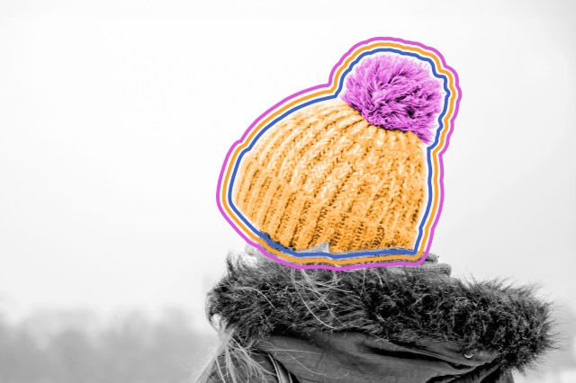 Woman wearing a beanie with a pompom on top