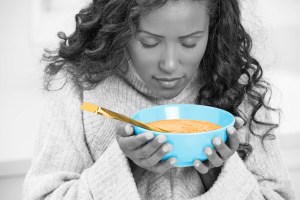 Woman holding a bowl of soup