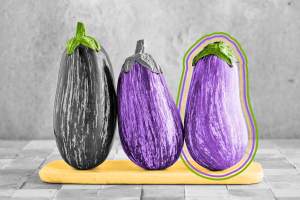 Three eggplants on a cutting board