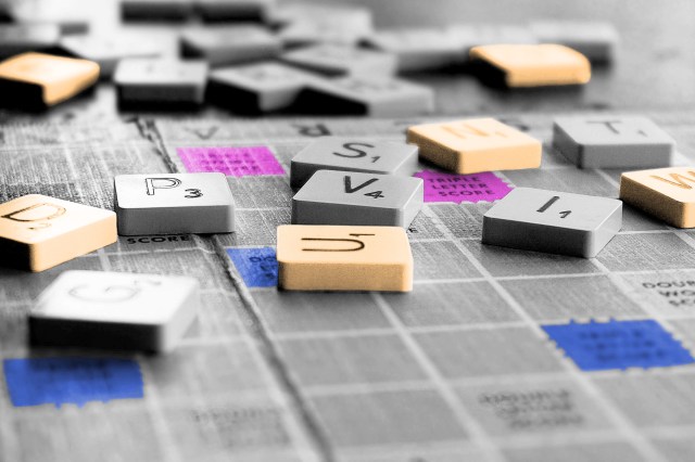 Assorted Scrabble pieces lying on the game board