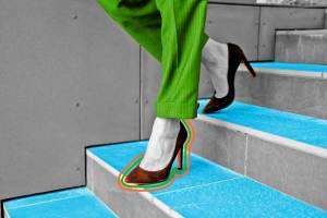 Close-up view of woman walking down the stairs in high heels