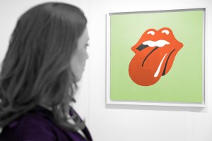 Woman looking at the Rolling Stones logo