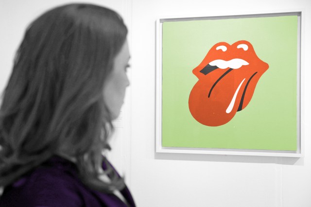 Woman looking at the Rolling Stones logo