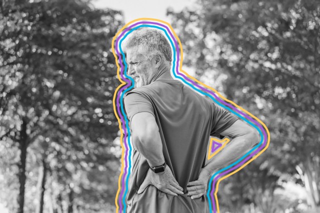 Older man wincing with his hands on his lower back