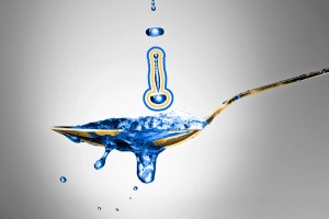 Cinematic close-up shot of water hitting a silver spoon