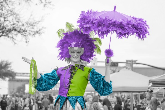 Person celebrating Mardi Gras dressed in festive garb