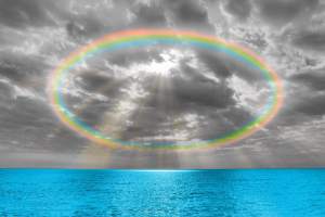 Rounded rainbow above the open sea